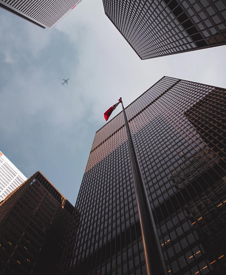 Office towers in downtown Vancouver, BC, with a Canadian flag